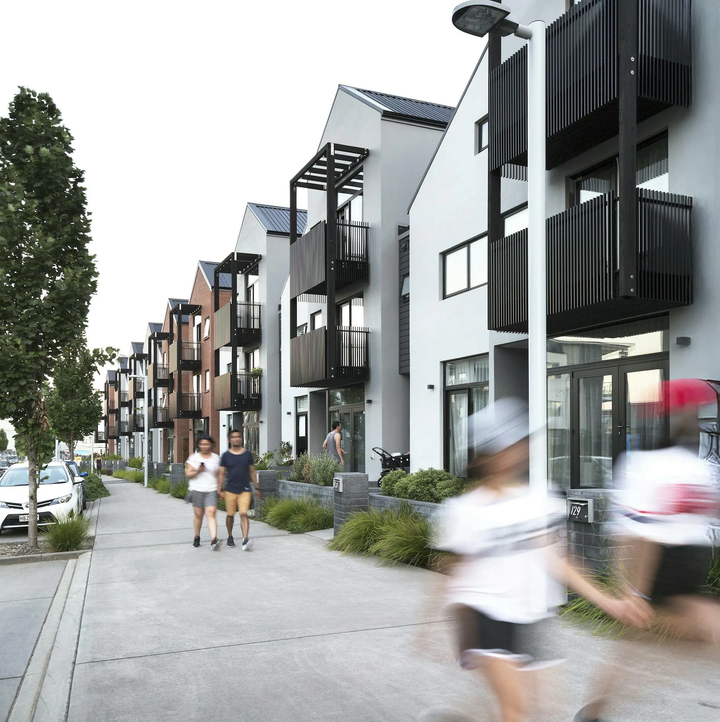 Hobsonville Point Buckley A Superlot 28 Terraces Lots 1 18 from Hobsonville Point Rd west at dusk Construkt Architects Auckland 2025 05 12 043822 mpuc