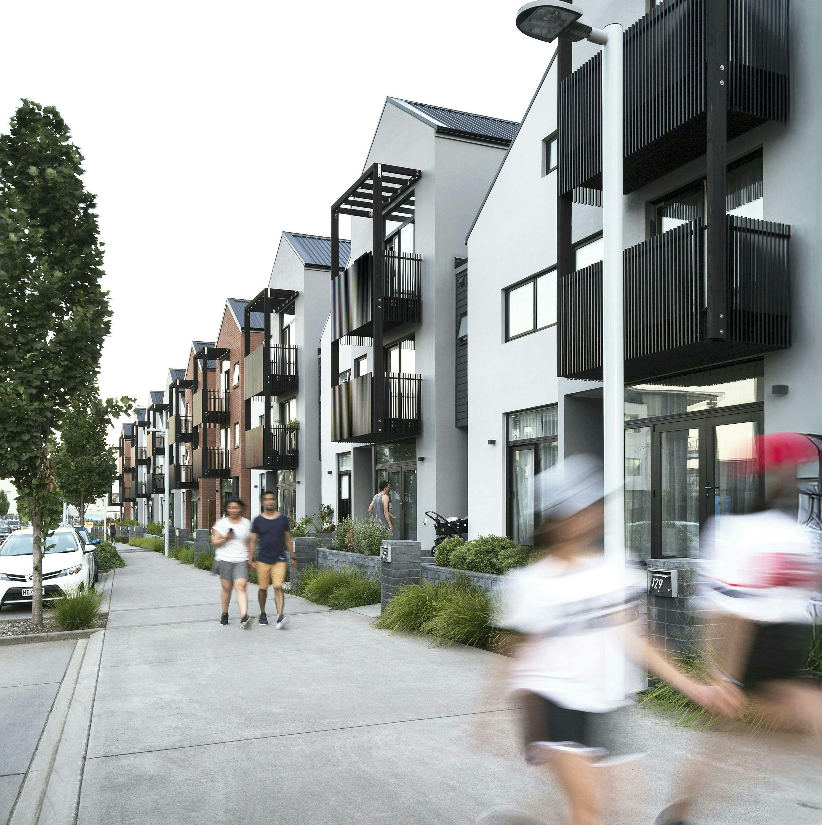 Hobsonville Point Buckley A Superlot 28 Terraces Lots 1 18 from Hobsonville Point Rd west at dusk Construkt Architects Auckland 2025 05 12 043822 mpuc