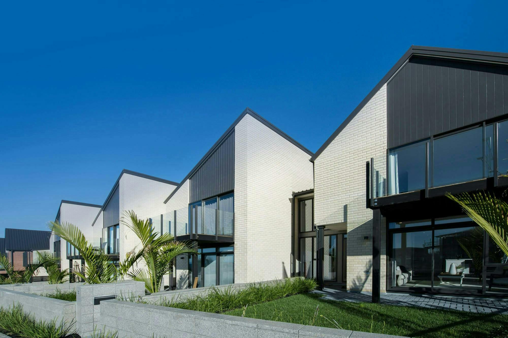 Long Bay Terraces Modern Terraces Construkt Architects Auckland White brick Cladding
